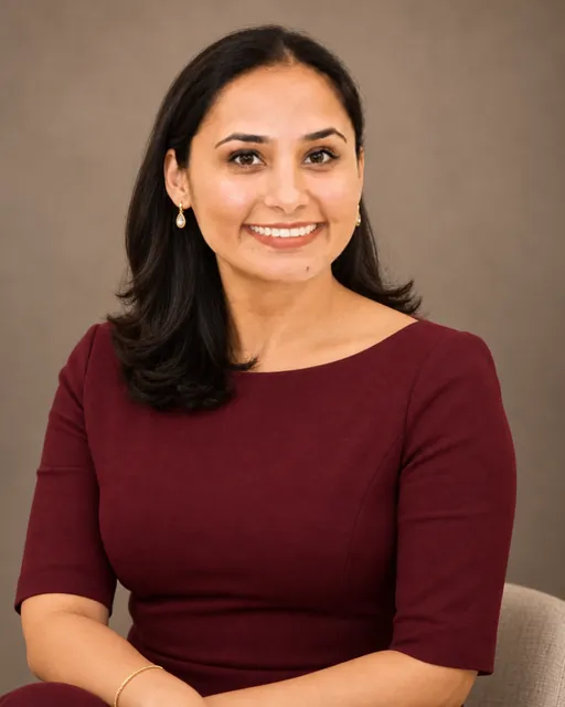 Raj Kiran Kaur seated, burgundy dress
